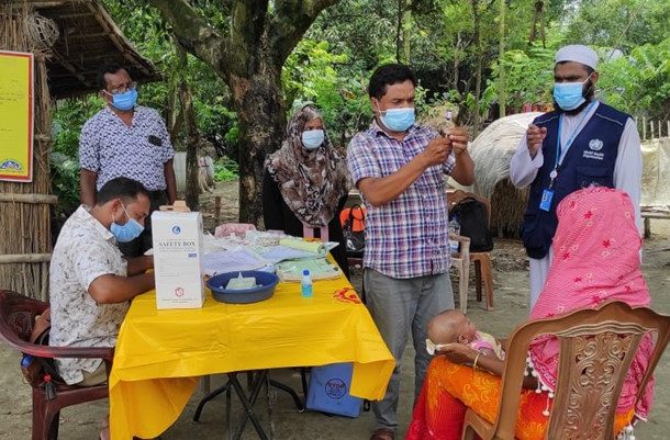 Dr. Faisal monitoring the quality of vaccination in an EPI Outreach vaccination session in the hard-to-reach village area during COVID-19 pandemic wave. Photo Credit: WHO Bangladesh